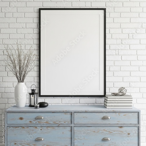 Vintage light blue dresser displaying decorative items against a white brick wall background with a framed blank canvas