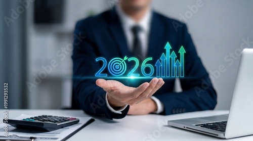 A businessman holding a glowing 2026 projection in his hand at a desk