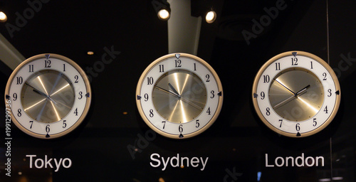 Photography Modern wall clocks display Tokyo, Sydney, London time zones