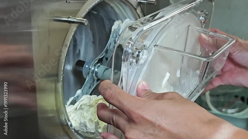 Ice cream maker machine. Ice cream falls into container.