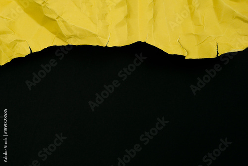 Yellow ripped paper torn edges strips isolated on black background