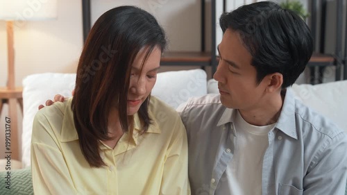 Couples family therapy with psychotherapist counselor support session for relationship and mental health, compassionate communication as man comforts partner, couples in cozy living room