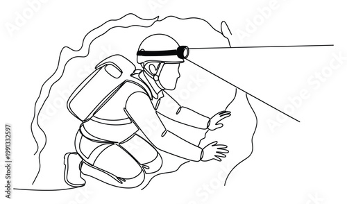 Adventurous cave explorer in protective gear with headlamp navigates a dark cavern for outdoor activity promotions