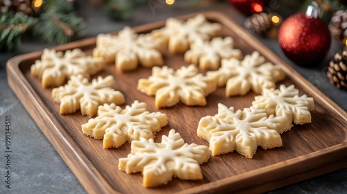 Festive Snowflake Sugar Cookies Arranged on a Wooden Tray for a Cozy Christmas Gathering