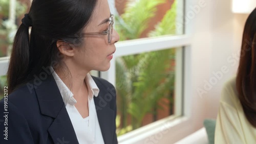 Couples family therapy counselor psychotherapist relationship support mental health counseling empathy adult pair hold hands on sofa, calm professional listens with care in bright office near window