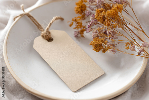 Blank Paper Tag on Ceramic Plate with Dried Flowers