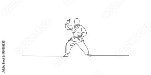 Continuous line drawing of a karate practitioner in a fighting stance isolated on white background