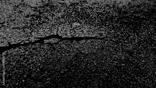 Photography Dramatic black and white grunge texture featuring large deep crack across gritty cement surface
