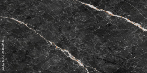 A close up of a black and white weathered rope rests against a rough grunge stone wall with an aged marble texture and dirty granite surface pattern