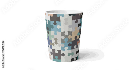 A colorful puzzle piece design on a paper cup sits on a plain white surface indoors.