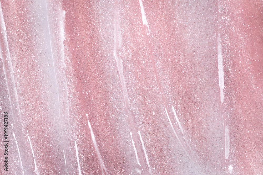 Fototapeta premium Pink glitter spreading on surface forming cosmetic texture background