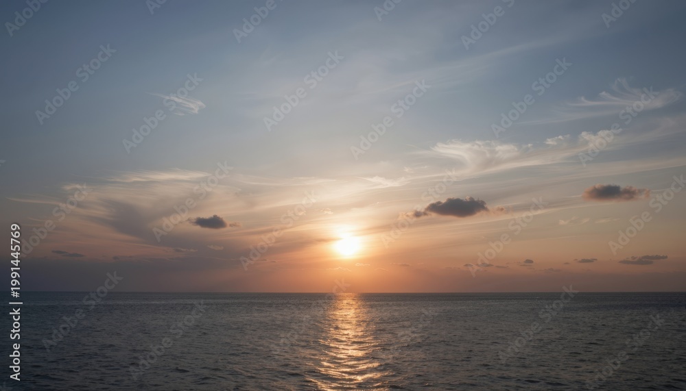 Fototapeta premium Serene Sunset Over Calm Ocean with Golden Reflections and Soft Clouds at Dusk
