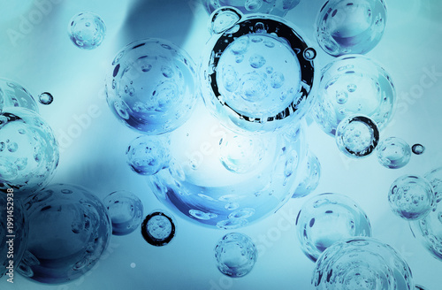 Abstract blue bubbles rising in liquid with light background
