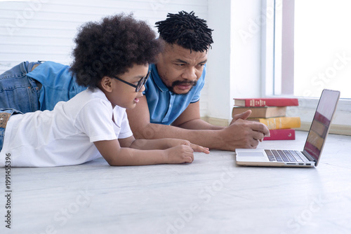 African father is teaching his son.