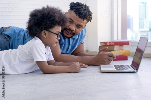 African father is teaching his son.