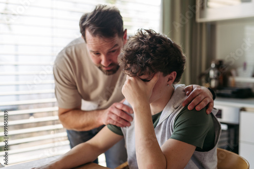 Obraz na plátně Father supporting struggling teenager with empathy and understanding