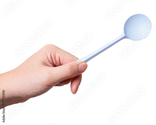 Female hand holding a white plastic spoon isolated on white background with a clipping path.