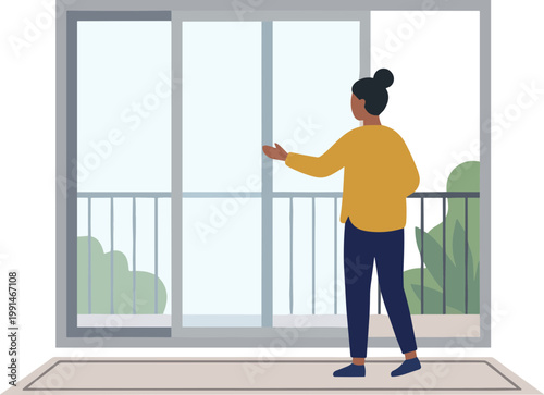 Woman opening sliding glass door on balcony with railing and green trees