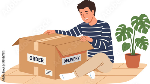 A man sits on floor unpacking order delivery cardboard box beside plant