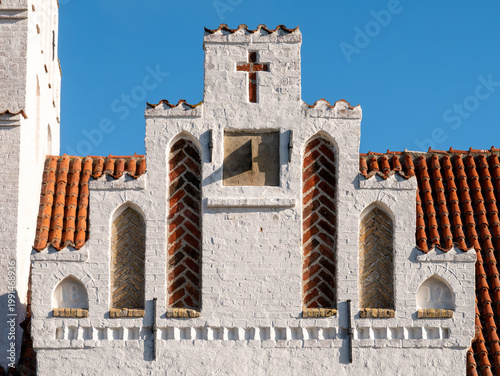 Facade detail with cross and stepped gable at Sejerø Kirke in Sejerby, Sejerø island in Kattegat, Denmark