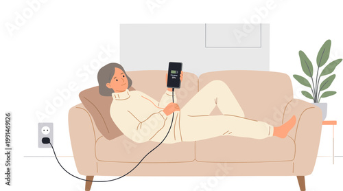 Man relaxing on couch with phone and charger in living room