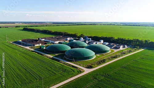 Biogas plant on green field.