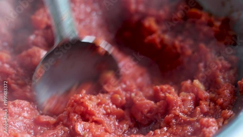 Close-up of gajar ka halwa being cooked and stirred in a pan. Traditional Indian sweet dish preparation, rich texture, hot dessert, rural lifestyle, poverty, slum village poor india concept.  