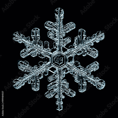 Obraz na plátně snowflake is a real winter natural macro crystal photo isolated on a dark backgr