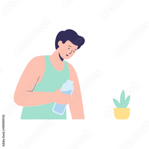 Man applies lotion on arm next to potted plant indoors