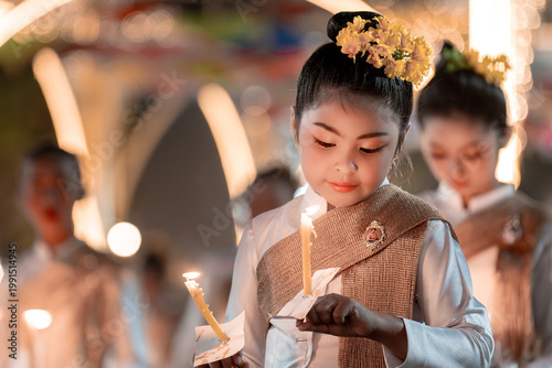 Young Girl Holding Candle in Festive Traditional Attire at Celebration