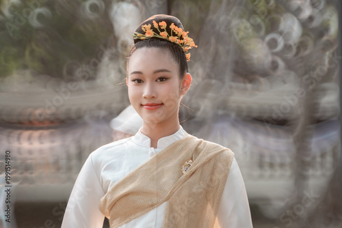 Young Woman in Traditional Attire with Floral Hair Accessories