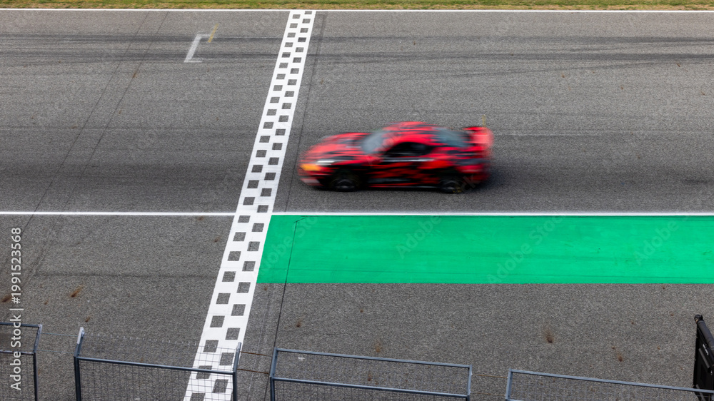 Obraz premium Motion blur, Race car racing on speed track, race car on road crossing start and finish line, Target business achieve and victory concept.