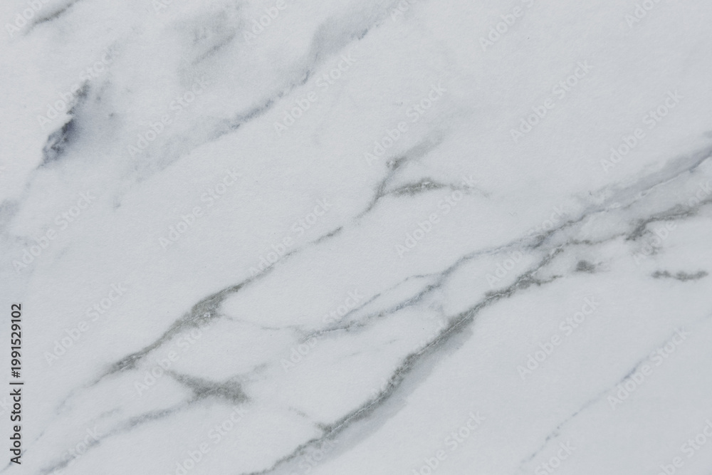 Obraz premium Close-up view of smooth white marble surface with subtle gray veins and textures