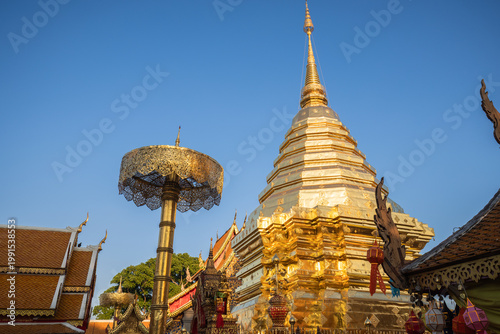 Bild auf Leinwand Gleaming golden stupa and ornate ceremonial umbrella under a clear sky at the sacred Wat Phra That Doi Suthep, Chiang Mai, Thailand
