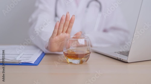 Doctor hand stop to refuse Whisky, quitting drink for healthy liver, prevent Alcoholic cirrhosis and cancer, World No Alcohol Day, medical advice for sobriety and Alcoholism and addiction concept