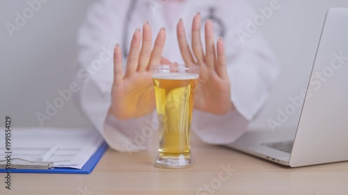 Doctor hand stop to refuse Beer, quitting drink for healthy liver, prevent Alcoholic cirrhosis and cancer, World No Alcohol Day, medical advice for sobriety and Alcoholism and addiction concept
