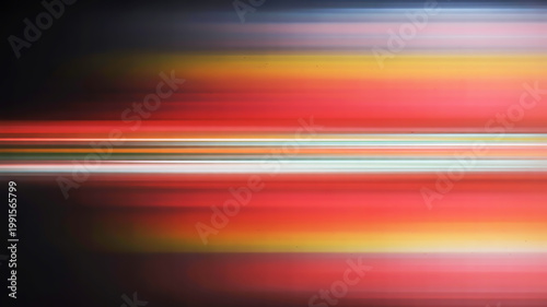 Abstract horizontal light streaks in red, orange, and yellow against a dark background, creating a sense of motion and energy