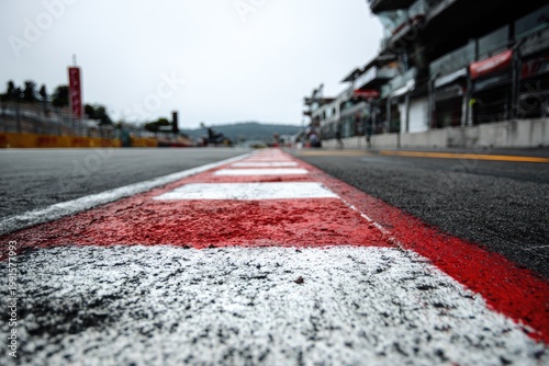 Close-up view of a racing track with red and white markings.