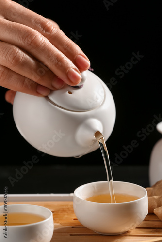 Female hands pouring hot te...