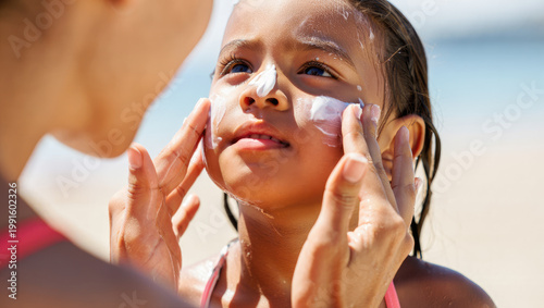 Child receiving sunscreen application on beach, sun protection, family vacation, skincare, parent-child bond, outdoor activity, summer essentials, advertising, health awareness