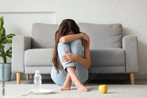 Young anorexic woman with a...