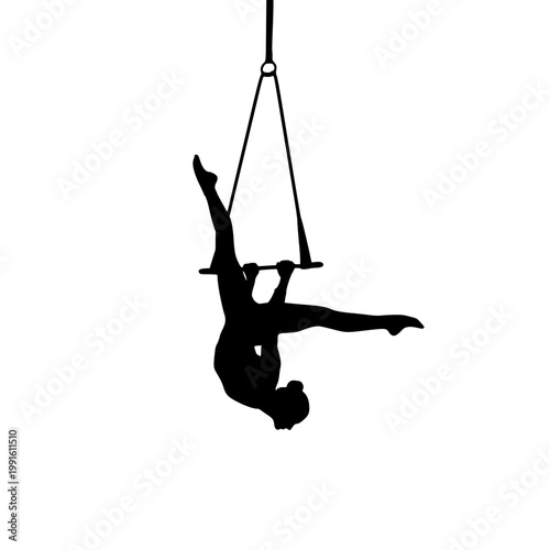 Aerialist gracefully performing an upside-down pose on a suspended fabric aerial hoop