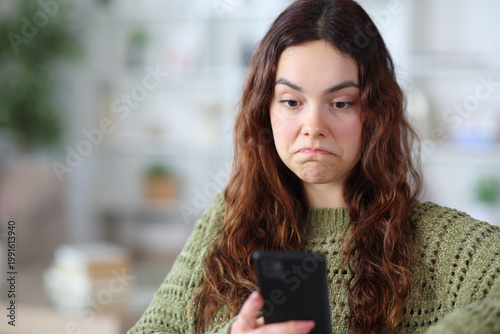 Photos Perplexed teen checking absurd online content on phone