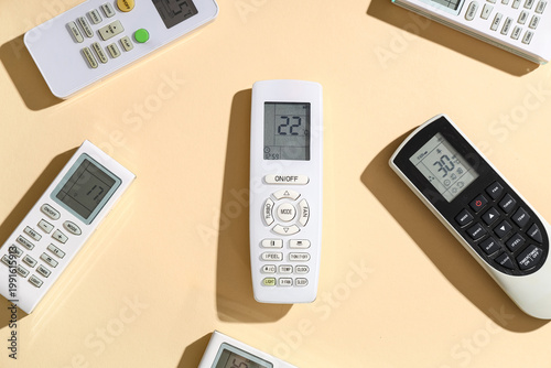 Valokuva Air conditioner remote controls on beige background