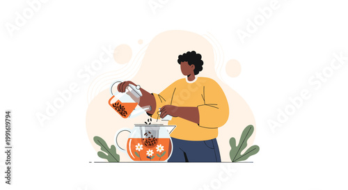 A person meticulously pours warm amber tea from a transparent glass kettle into a larger pot decorated with delicate white daisy flower patterns.