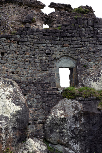 Ancient stone wall and arched window of a medieval fortress. Isolated, transparent PNG