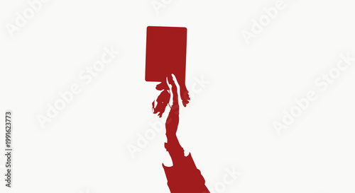 Red card held by a referee signifies a disqualification or serious penalty during a professional sports match.