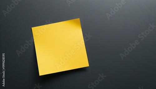 Simple Yellow Sticky Note on a Dark Surface Ideal for Message and Reminder Applications