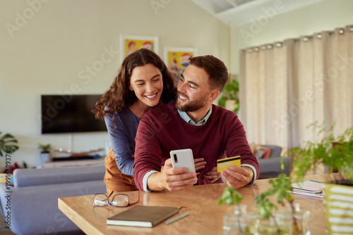 Couple doing online shopping with phone and credit card