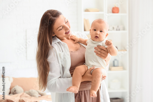Mother holding her baby in ...